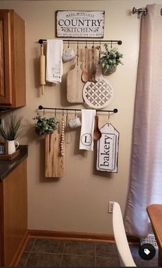 a kitchen with wooden utensils hanging on the wall next to a potted plant