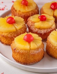 small pineapples with cherries are on a white plate, ready to be eaten