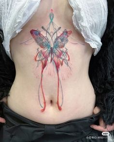 a woman's stomach with a butterfly tattoo on her belly and the bottom part of her abdomen