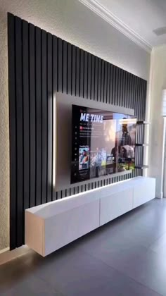 a flat screen tv mounted to the side of a wall