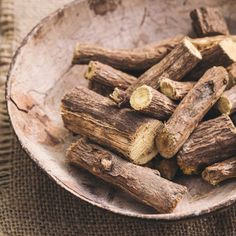 a wooden bowl filled with cut up logs