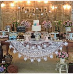 a table topped with lots of cakes and cupcakes