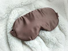 buyers, you are Welcome!  Luxury silk brown Sleep mask  from natural fabric!  Pamper yourself with a wonderful night's sleep.  Perfect gift for everyone: for children, friends, parents :) And the exterior is a beautiful colorful fabric to complement your night clothes. These cute silk eye masks can be used for headaches that are sensitive to light, and those long flights when you just want to rest.  It will become your indispensable attribute to travel by train, plane, bus, as well as for those who are engaged in yoga, it is useful during meditation. Skin around the eyes is the most delicate and sensitive, so I use a hypoallergenic, soft and natural fabrics. Each sleep mask I make from high quality 100% silk fabric! It is eco-friendly and hypoallergenic material. I use silk for my sleep ma Night Clothes, Sleep Eye, Silk Eye Mask, Colorful Fabric, Long Flights, Eye Masks, Natural Sleep, Sleeping Mask, Natural Fabric