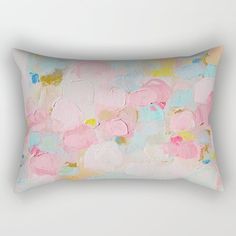 a pink and blue rectangular pillow on a white wall