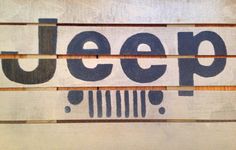 the jeep logo is painted on wood planks