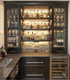 a home bar with wine glasses and liquor bottles