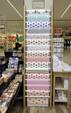 the shelves are filled with different types of paper and supplies for sale at the store