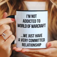 a woman holding a coffee mug with the words i'm not added to world of warcraft