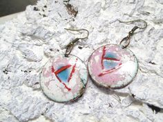 Cute round earrings in white, red, blue and yellow These handmade hanging earrings are enamelled, a real one-of-a-kind, created in my little jewelry studio. The trailers are made of copper and enamelled on both sides The earrings are made of bronze Enamel is glass powder that is burned to metal in an extra oven at very high temperatures. They are delivered in an organzast, so they can be given away very well. Please note that the piece of jewelry should not fall down as it is fragile or gets sla Handmade White Enamel Earrings, Unique White Enamel Earrings, Artsy White Round Jewelry, White Enamel Round Earrings, White Round Enamel Earrings, Vintage White Hand Painted Earrings, Vintage Hand Painted White Earrings, Magical Earrings, Handmade Hanging