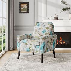 a chair sitting on top of a rug in front of a fireplace