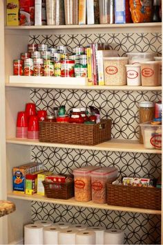 an organized pantry with lots of food on the shelves and baskets in front of it