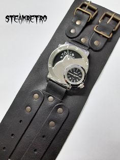 THIS PRICE ONLY AVAILABLE WHILE STOCKS LAST Big, bold, and unusual this Steampunk watch definately makes a statement. If your a wallflower this watch is NOT for you. If you want to stand out from the crowd this is an essential accessory for all Steampunk afictionados! Featuring dual time display, you can set two different time zone no matter where you travel in space and time. A silver face, and a stunning Quartz movement keeps the whole thing timelessly ticking over! The Movements are manufactu Black Steampunk Watch As A Gift, Black Steampunk Watch As Gift, Steampunk Black Watch As A Gift, Steampunk Black Watch As Gift, Steampunk Black Watch For Gift, Vintage Black Watch Accessories For Everyday Use, Steampunk Style Watch With Leather Strap As A Gift, Steampunk Adjustable Quartz Watch, Steampunk Watches With Leather Strap As Gift