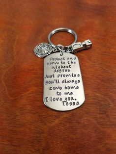 a keychain with a quote on it sitting on top of a wooden table