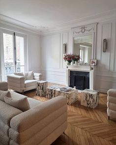 a living room filled with furniture and a fire place in the middle of a room