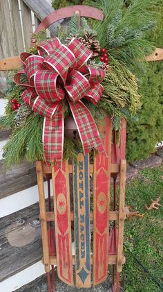 a wooden sled with a bow on it