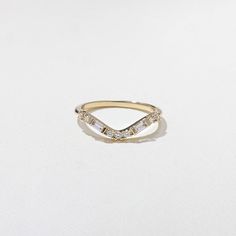 a gold ring with three diamonds on it