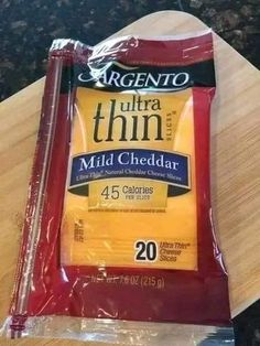 a bag of cheese sitting on top of a wooden table