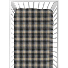 a baby crib with a black and tan plaid blanket