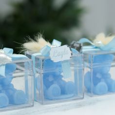 three clear boxes with blue candies in them