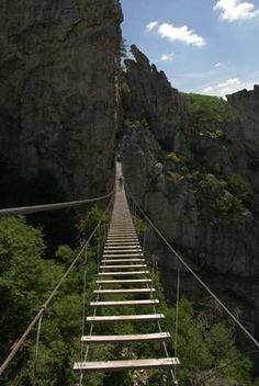 there is a long suspension bridge going up the mountain