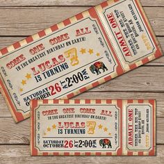 two circus tickets sitting on top of a wooden table