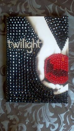 a red rose sitting on top of a black and white brochure with the words twilight