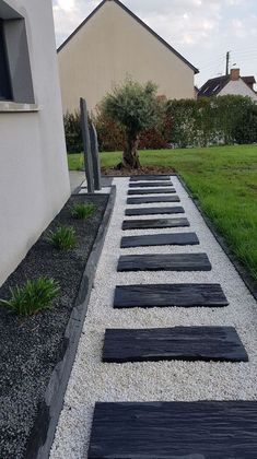 an outdoor walkway made out of black stones