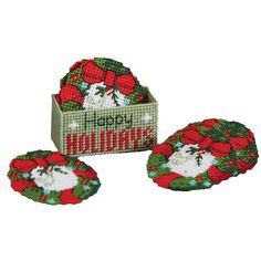 three christmas coasters in a box with the words happy holidays written on one side