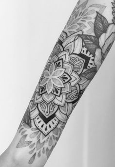 a person's arm with a tattoo on it and a flower in the middle