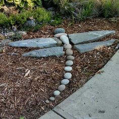 a dragonfly made out of rocks sitting on the ground