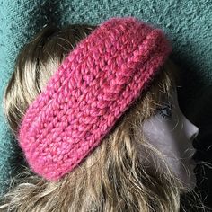 a mannequin head wearing a pink knitted hat