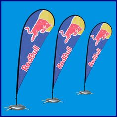 three red bull feather flags with blue sky in the background