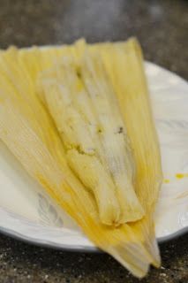 two pieces of corn on a white plate