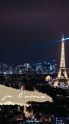 the eiffel tower is lit up at night with lights in the city below