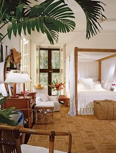 a bedroom with wicker furniture and palm trees