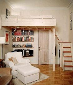 a living room with a loft bed next to a stair case and bookshelf