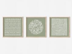 three green and white art prints hanging on a wall