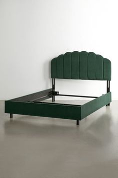 a green bed frame with an upholstered headboard and foot board in the middle