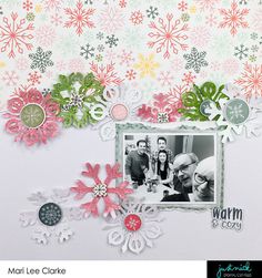 a scrapbook page with snowflakes, buttons and a family photo on it