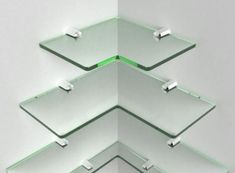 three glass shelves stacked on top of each other in the shape of an upside down triangle