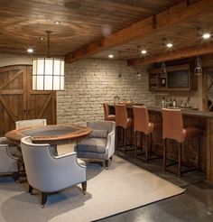 a home bar with chairs around it and a table in the center surrounded by stools