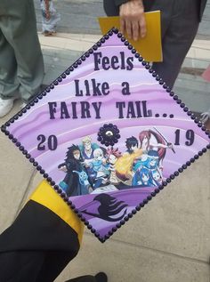 a purple and black graduation cap that says feels like a fairy tail