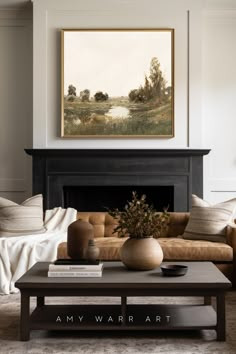 a living room with a couch, coffee table and painting on the wall above it