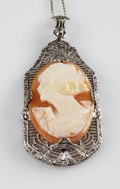 *18 inch Sterling Silver Chain *Weighs-4.4 grams *Beautiful, left facing, carved shell cameo set in an elaborate Sterling Silver Filigree Frame.  *Elegant Statement on the neck. *In Excellent Estate condition. Shows very minor signs of wear & patina. The cameo is securely set.  *Stamped Sterling (on pendant) & Sterling (on chain). *Highly collectible piece. *Heirloom quality necklace. This piece is special & it sparkles beautifully. *You will receive the exact item in the photographs. Antique Gold Cameo Necklace, Silver Cameo Metal Necklace, Ornate Antique Gold Cameo Necklace, Collectible Cameo Pendant Necklace, 1920s Necklace, Ornate Cameo Necklace Collectible, Aquamarine Bracelet, Carved Shell, Cameo Necklace