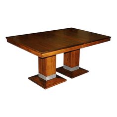 a wooden table with two metal pedestals on each side and a square shaped top