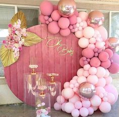 a pink and gold birthday party with balloons, champagne flutes, vases and decorations