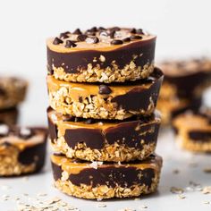 chocolate covered cookies stacked on top of each other with oats and peanut butter in the middle