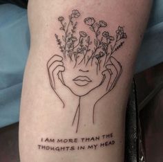 a woman's leg with flowers and the words i am more than the thoughts in my head