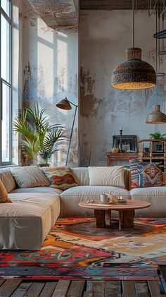 a living room filled with lots of furniture next to a large window and potted plant