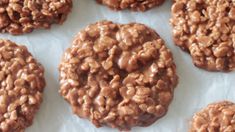 chocolate cookies are arranged on wax paper